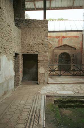 Inside a large house with tile floors in the atrium.