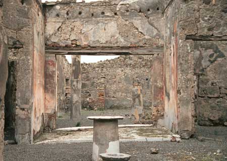 Two story house. The row of holes would have held wooden posts across the ceiling to form a floor above.